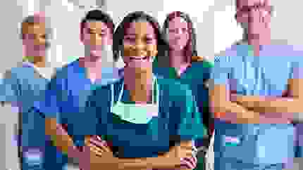 A group of happy doctors in scrubs